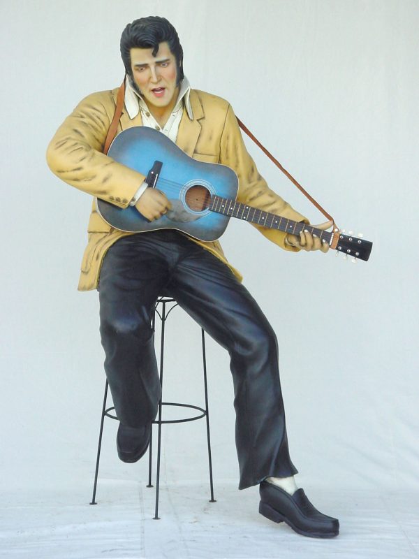ROCK & ROLL SINGER SITTING WITH GUITAR