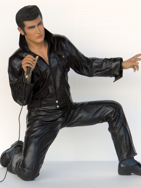 ROCK & ROLL SINGER KNEELING WITH MICROPHONE